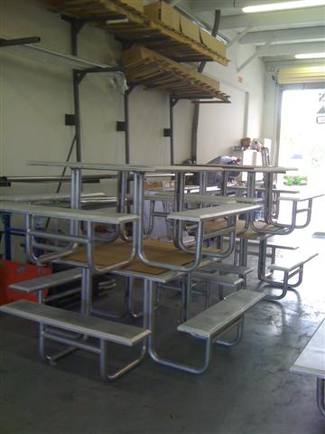 All aluminum pre-powdercoated 4'x4' picnik tables with cnc bent 1 1/2" pipe legs and formed 1/8" table top and benches